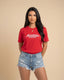 Woman wearing a red t-shirt with 'Montavor Western Wear' text on a beige background