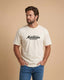 Man wearing a white t-shirt with 'Montavor Western Wear' text on a beige background