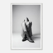 Framed black and white art print of a person sitting with legs crossed wearing cowboy boots.