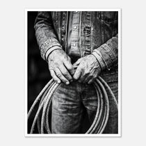 Black and white photograph of cowboy hands holding a coiled rope wearing denim, western ranch wall art.