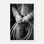 Black and white photograph of cowboy hands holding a coiled rope wearing denim, western ranch wall art.