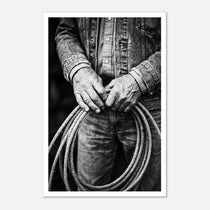 Black and white photograph of cowboy hands holding a coiled rope wearing denim, western ranch wall art.