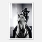Black and white photograph of a cowgirl riding a horse head on wearing a cowboy hat, western equestrian wall art.