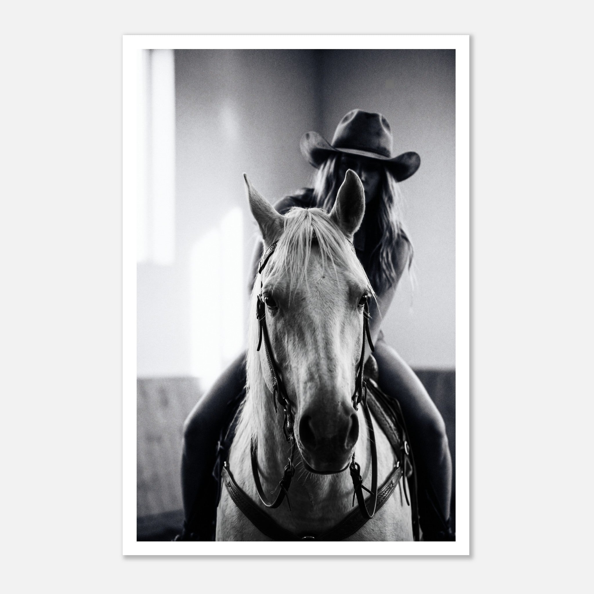 Black and white photograph of a cowgirl riding a horse head on wearing a cowboy hat, western equestrian wall art.