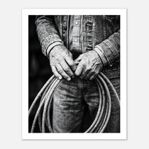 Black and white photograph of cowboy hands holding a coiled rope wearing denim, western ranch wall art.