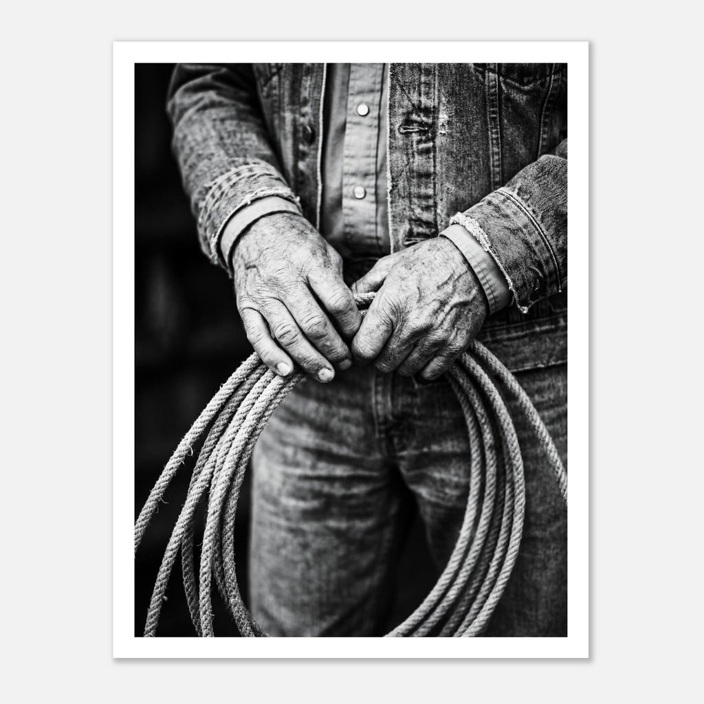 Black and white photograph of cowboy hands holding a coiled rope wearing denim, western ranch wall art.