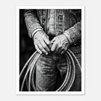 Black and white photograph of cowboy hands holding a coiled rope wearing denim, western ranch wall art.