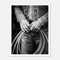 Black and white photograph of cowboy hands holding a coiled rope wearing denim, western ranch wall art.