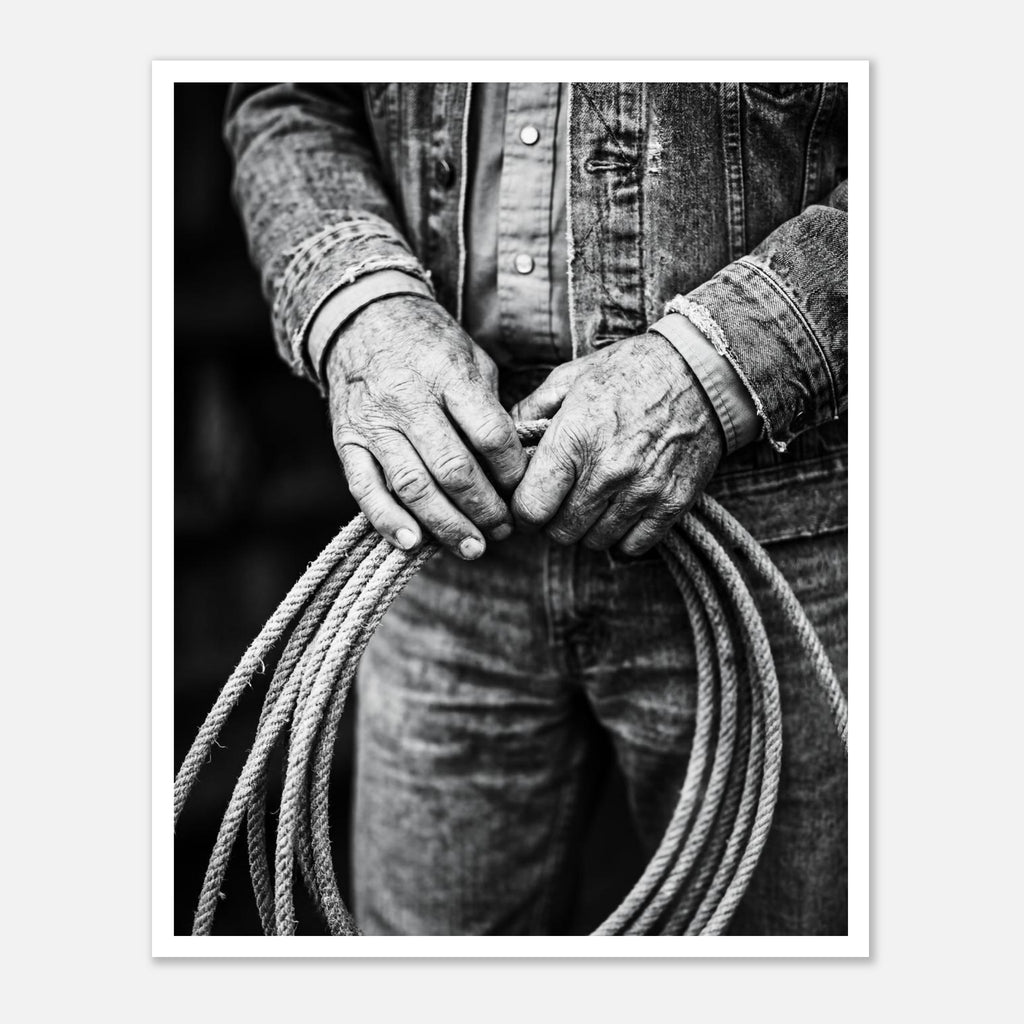 Black and white photograph of cowboy hands holding a coiled rope wearing denim, western ranch wall art.