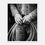Black and white photograph of cowboy hands holding a coiled rope wearing denim, western ranch wall art.