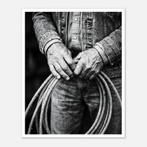 Black and white photograph of cowboy hands holding a coiled rope wearing denim, western ranch wall art.