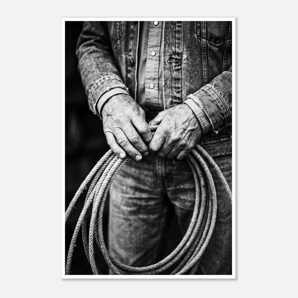 Black and white photograph of cowboy hands holding a coiled rope wearing denim, western ranch wall art.