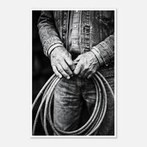 Black and white photograph of cowboy hands holding a coiled rope wearing denim, western ranch wall art.