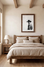 Black and white photograph of a rodeo cowboy wearing a western hat and cigarette, turning toward the camera after competition, western cowboy wall art poster.