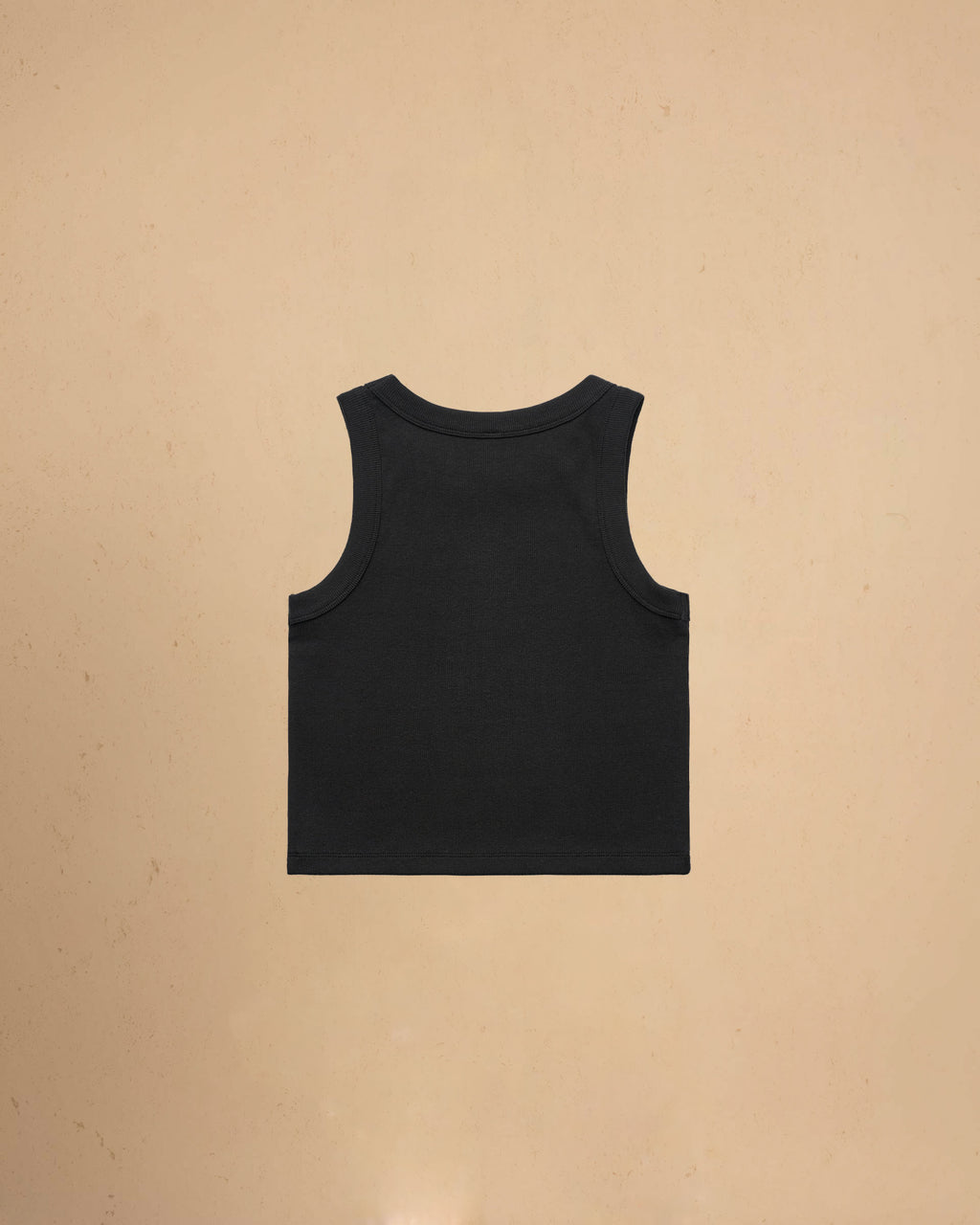 Black tank top on a beige background