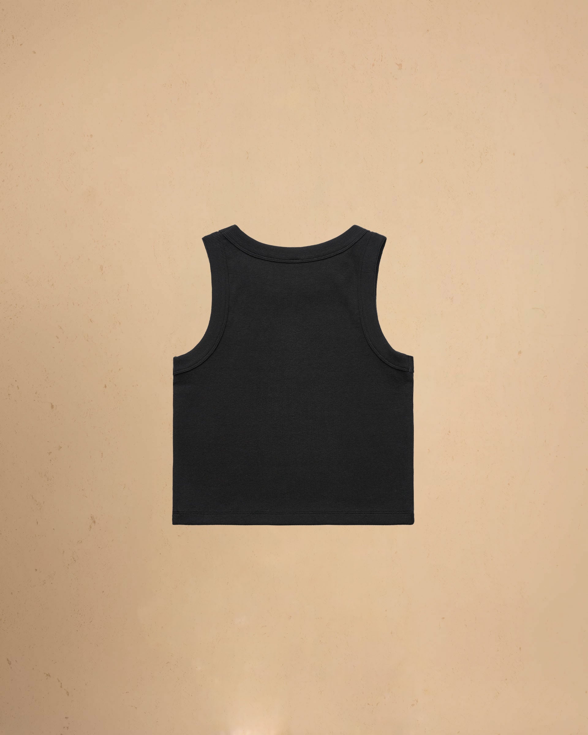 Black tank top on a beige background