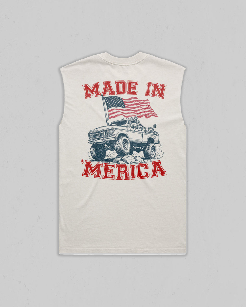 A sleeveless white tank top with a large graphic print on the front. The graphic features the text 'MADE IN MERICA' in red, an American flag, and a vintage off-road pickup truck illustration.