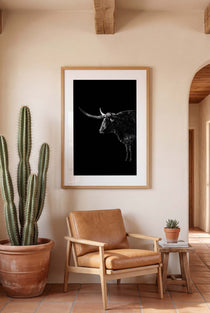 Black and white portrait of a Texas Longhorn with large sweeping horns emerging from darkness, western ranch wall art poster.