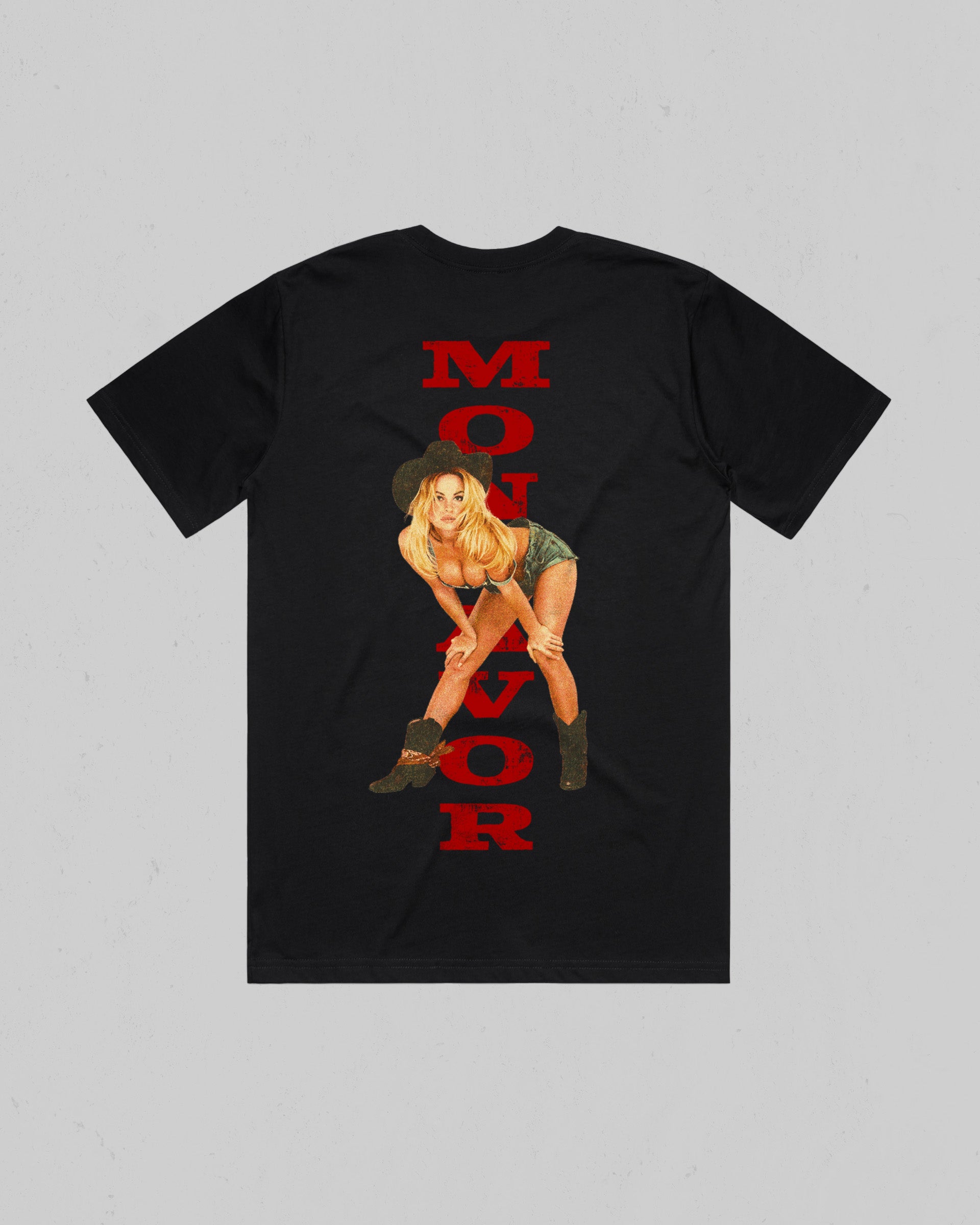 A black short-sleeve t-shirt with a graphic print on the back. The print features the word 'MONTAVOR' in bold red letters vertically aligned, overlaid with an illustration of a blonde woman in a cowboy hat and boots. Main image