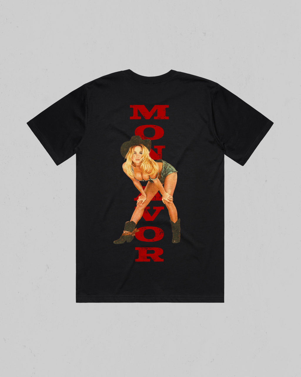 A black short-sleeve t-shirt with a graphic print on the back. The print features the word 'MONTAVOR' in bold red letters vertically aligned, overlaid with an illustration of a blonde woman in a cowboy hat and boots.