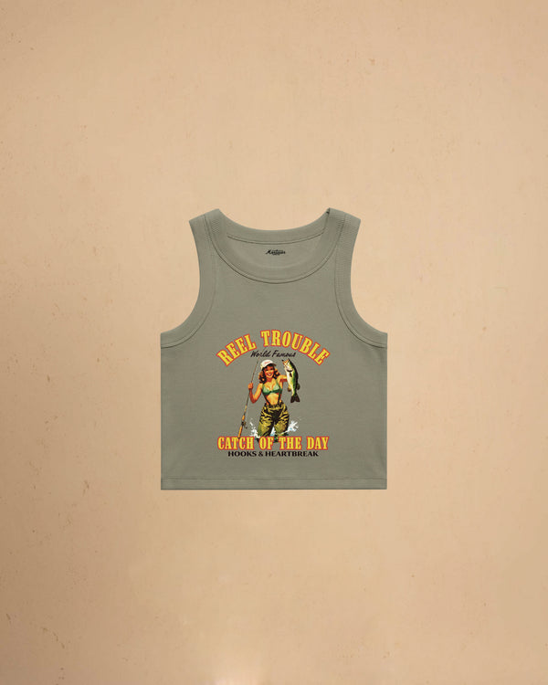 Women’s Reel Trouble organic crop tank featuring a vintage fishing pin-up graphic with retro western styling and heavyweight ribbed cotton construction.