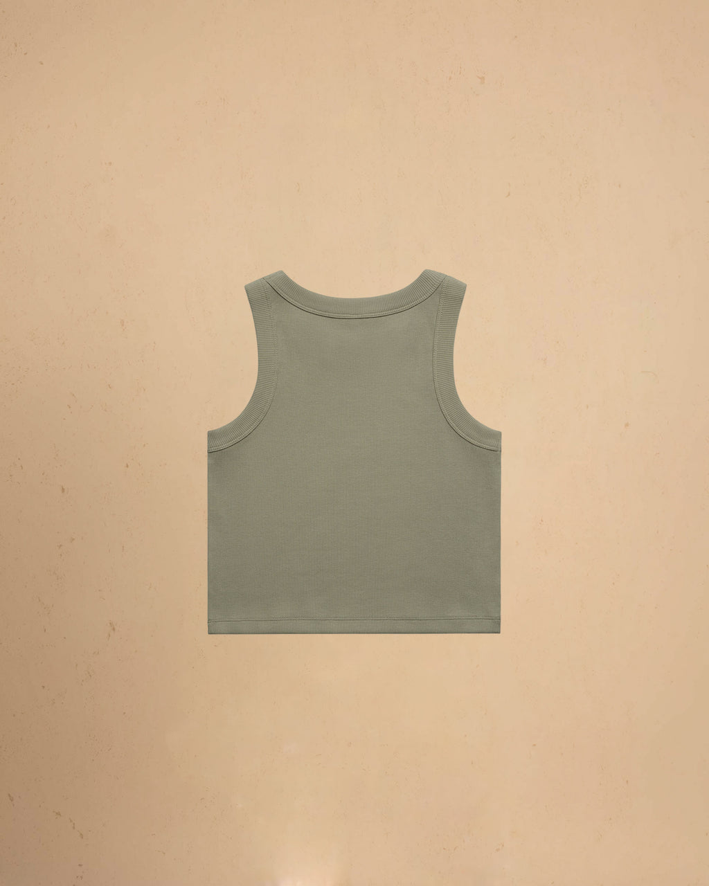 Green tank top on a beige background