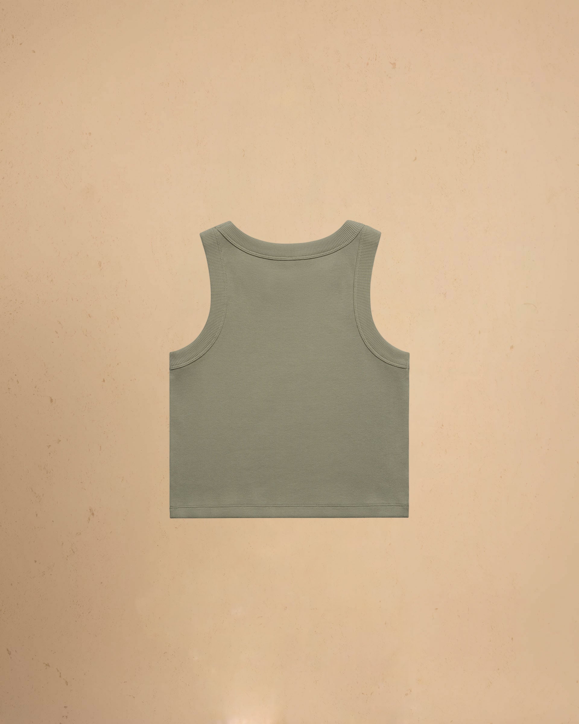 Green tank top on a beige background