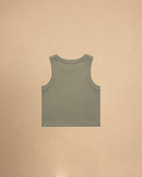 Green tank top on a beige background