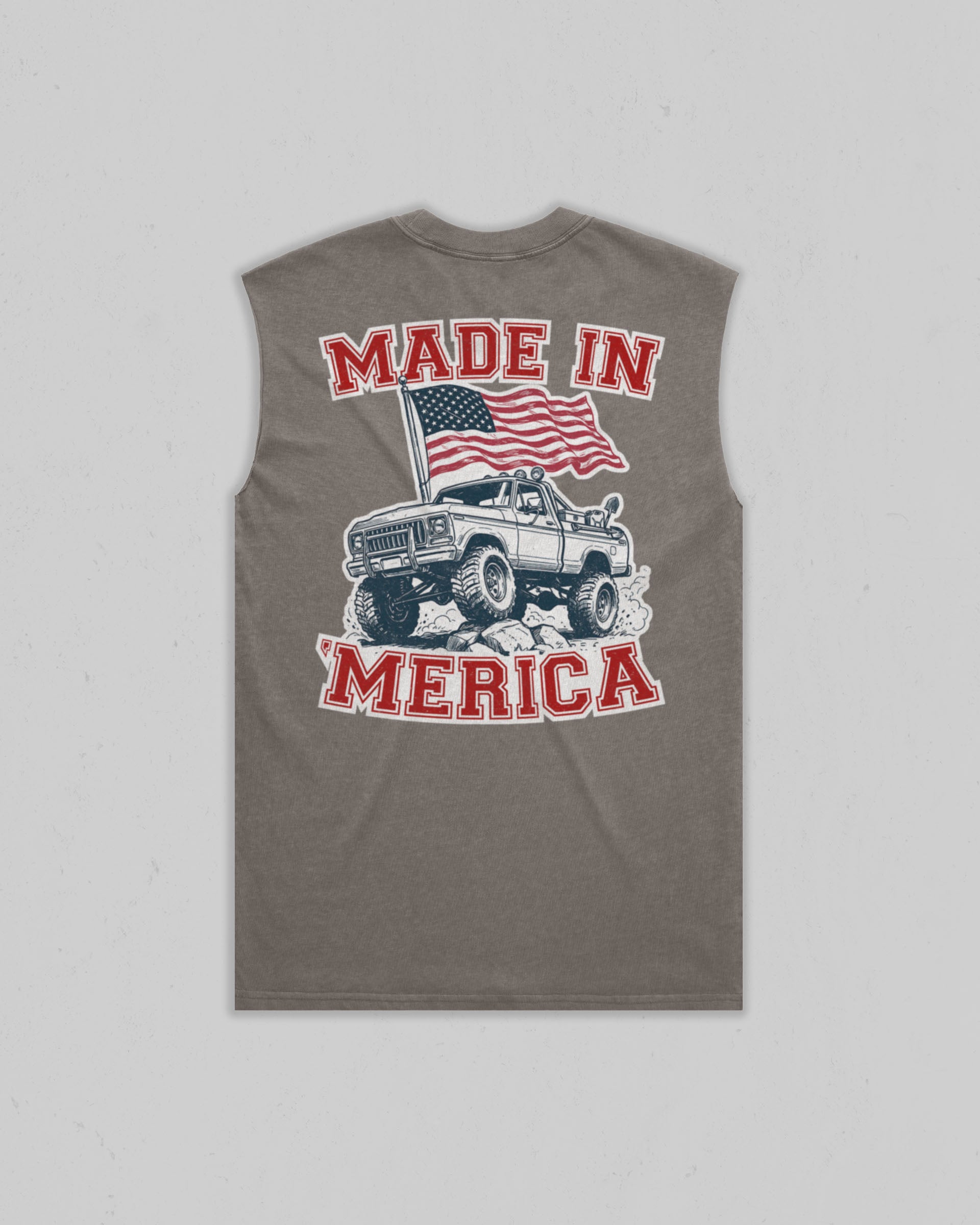 A sleeveless gray t-shirt with a graphic on the front featuring a white pickup truck, an American flag, and the text 'MADE IN MERICA' in red and white.