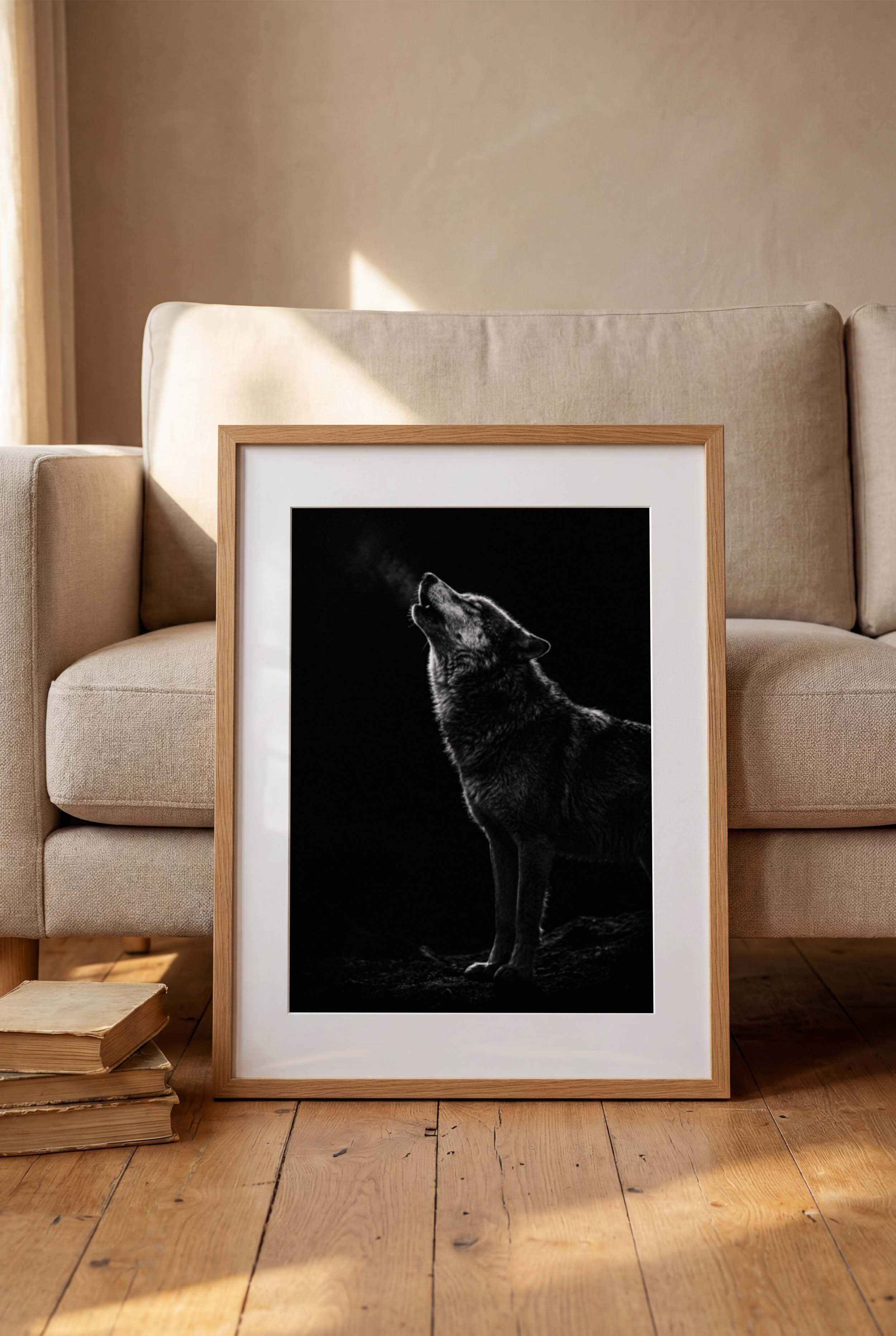Black and white photograph of a wolf howling into the night with visible breath in cold air, wildlife wall art poster.