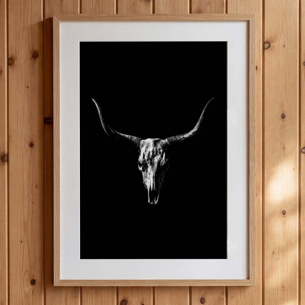 Black and white photograph of a longhorn skull with wide sweeping horns centered against a dark background, western wall art poster.