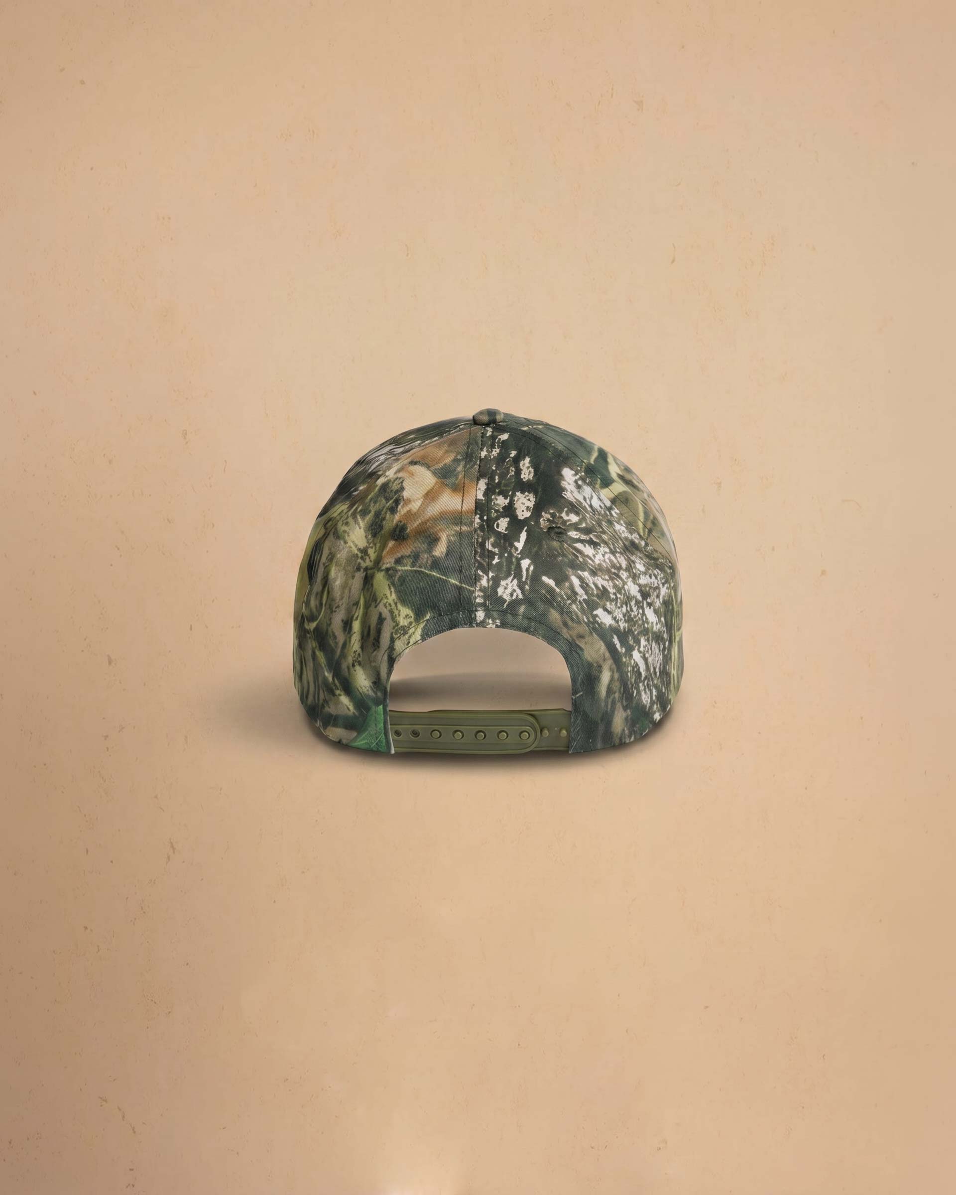 Camouflage baseball cap with 'Midnight Rodeo Club' text on a beige background