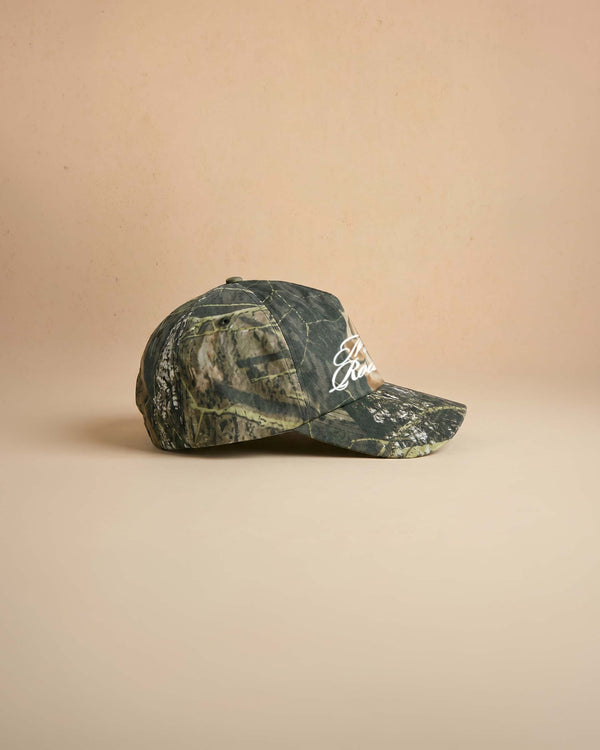 Camouflage baseball cap with 'Midnight Rodeo Club' text on a beige background
