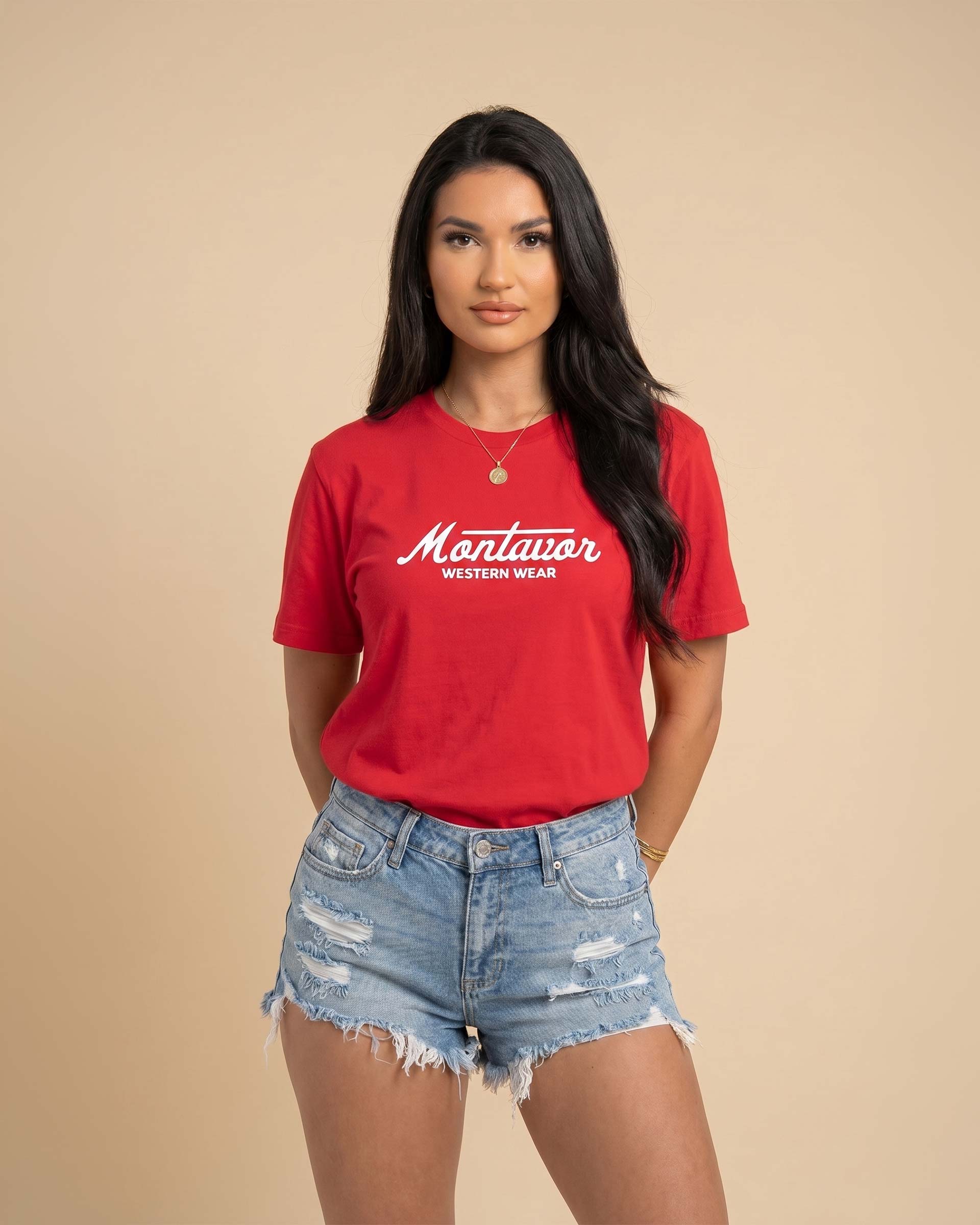 Woman wearing a red t-shirt with 'Montavor Western Wear' text on a beige background Main image
