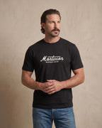 Man wearing a black t-shirt with 'Montavor Western Wear' logo against a beige background