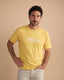 Man wearing a yellow t-shirt with 'Montavor' branding against a beige background