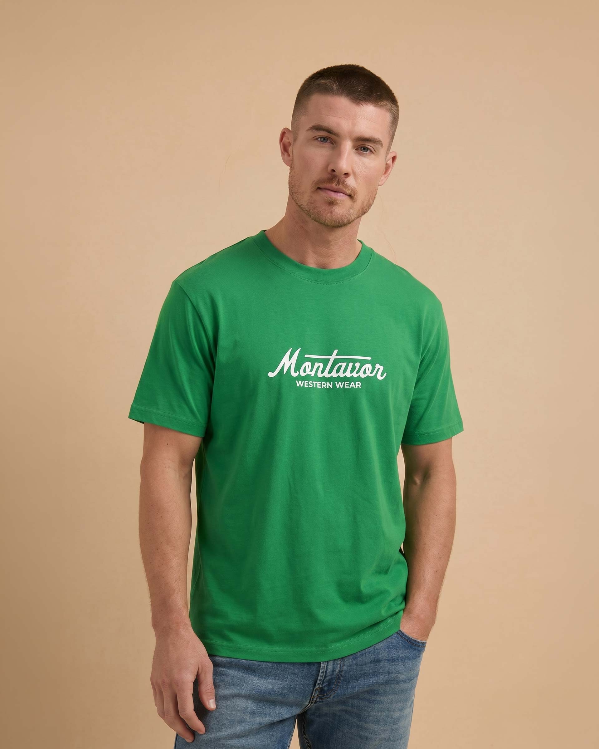 Man wearing a green t-shirt with 'Montavor' logo on a beige background