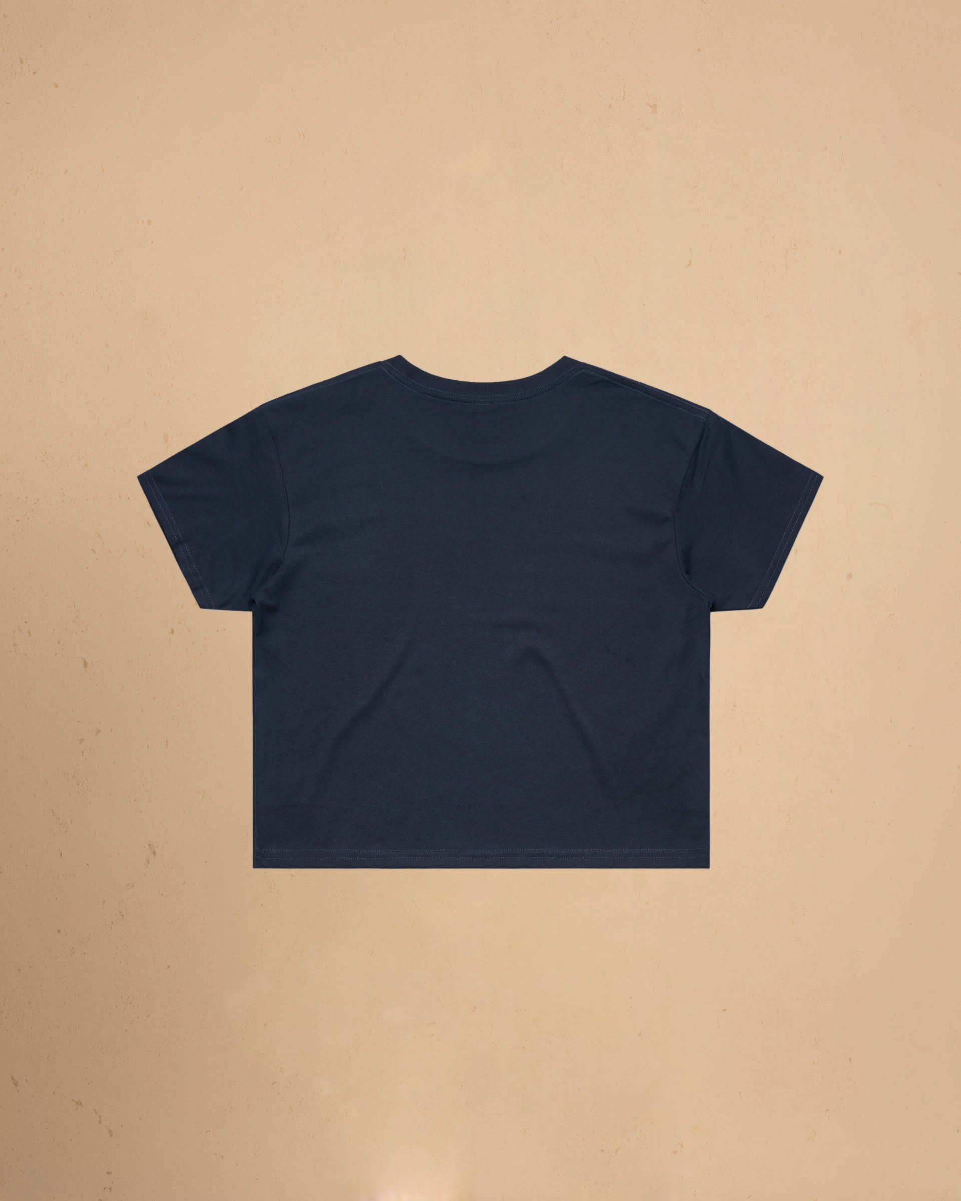 Navy blue t-shirt on a beige background