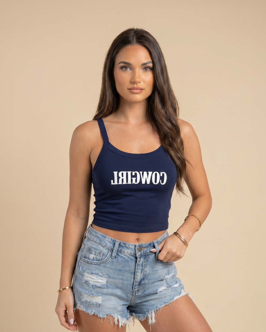 Fitted western-inspired strap tank top featuring mirrored “Cowgirl” typography on the front with a soft micro rib silhouette.