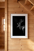 Black and white portrait of a bull elk with large antlers emerging from darkness, western wildlife wall art poster.