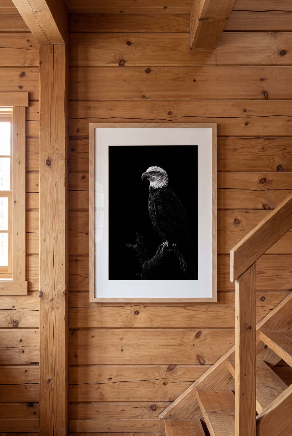 Black and white portrait of a bald eagle perched on a branch against a dark background, wildlife wall art poster.
