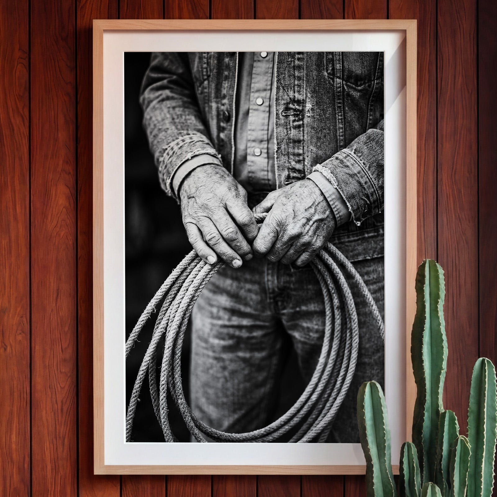 Black and white photograph of cowboy hands holding a coiled rope wearing denim, western ranch wall art.