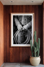 Black and white photograph of cowboy hands holding a coiled rope wearing denim, western ranch wall art.