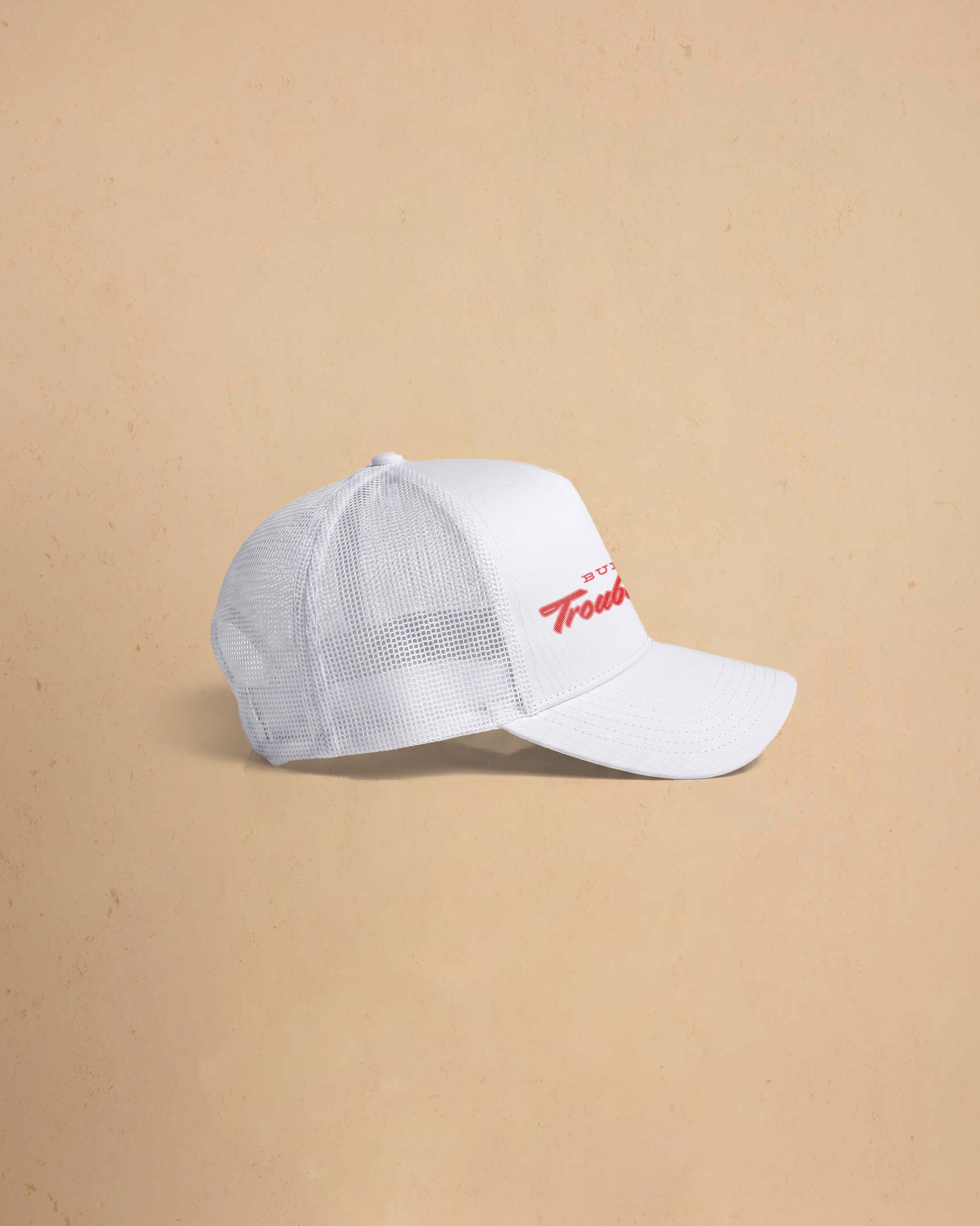 Built For Trouble trucker cap featuring a bold Western-inspired graphic on a high-profile foam-front snapback cap with breathable mesh backing.