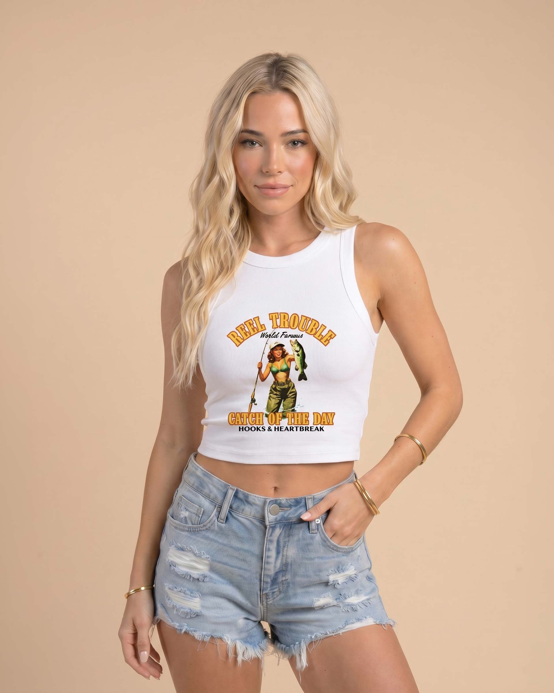 Women’s Reel Trouble organic crop tank featuring a vintage fishing pin-up graphic with retro western styling and heavyweight ribbed cotton construction.