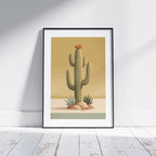 Minimalist desert poster featuring a tall saguaro cactus with a burnt orange bloom, surrounded by desert plants and rocks against a soft golden sky in muted mid century tones.
