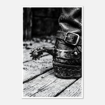 Black and white close up of a cowboy boot with metal spur on wooden floor, western ranch wall art.