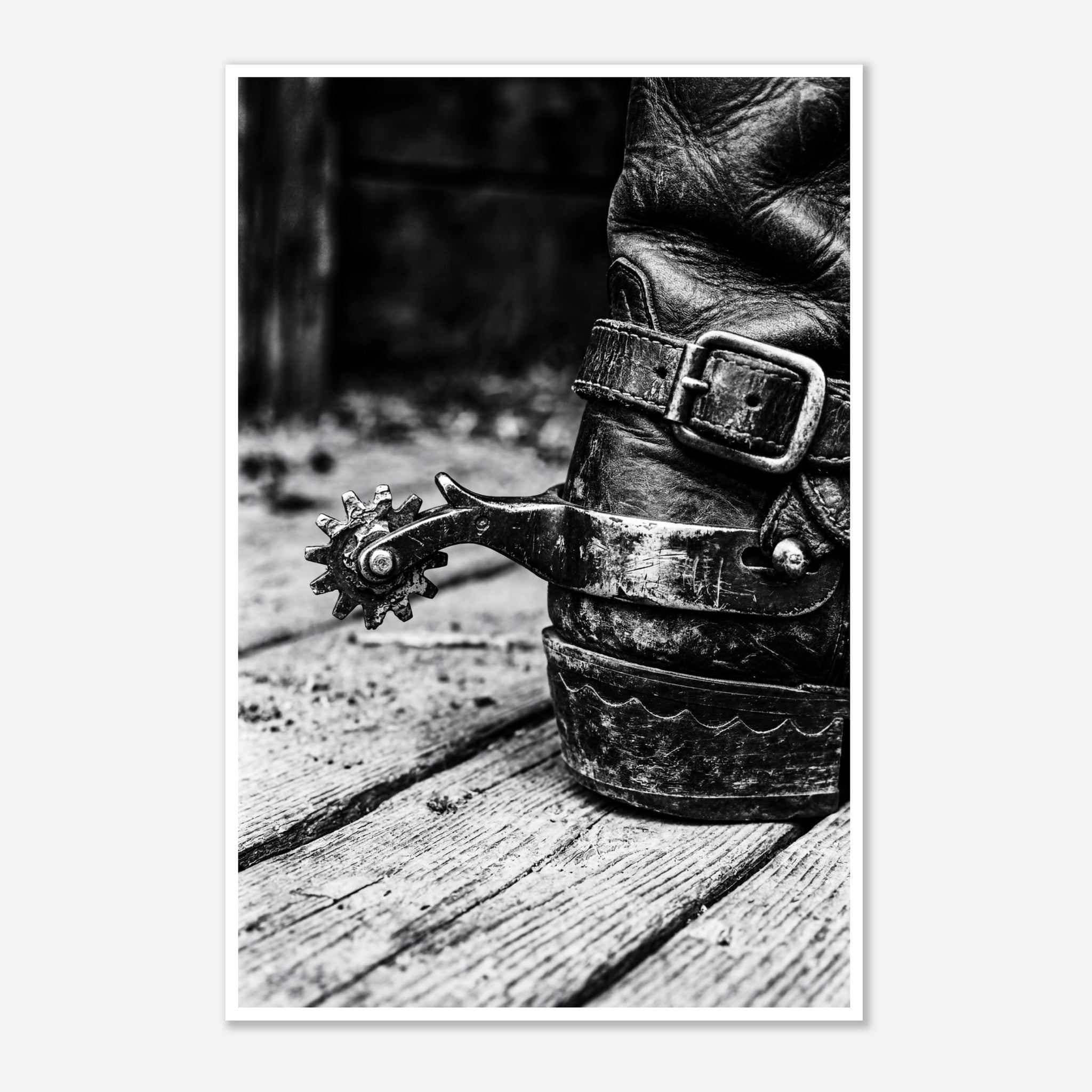 Black and white close up of a cowboy boot with metal spur on wooden floor, western ranch wall art.