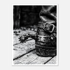Black and white close up of a cowboy boot with metal spur on wooden floor, western ranch wall art.