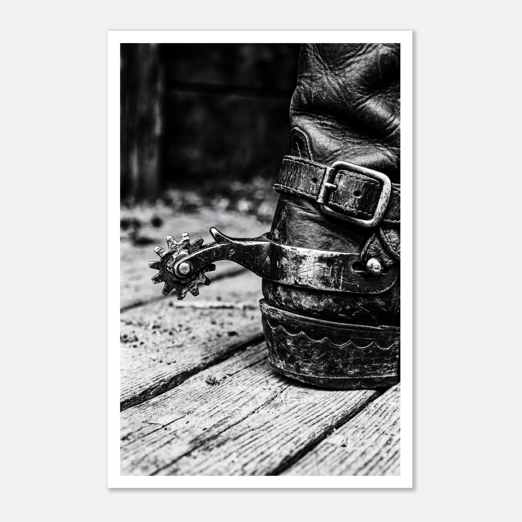 Black and white close up of a cowboy boot with metal spur on wooden floor, western ranch wall art.
